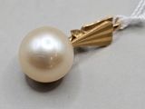 collier composé d'une perle blanche et d'une chaîne en or sur un fond gris