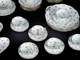 many pieces of china on a black table
