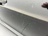 a person that is cleaning a car with a sponge