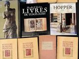 a lot of books that are on a black table