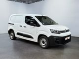 the white van is parked in a large white room