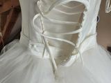 a white dress on a mannequin in a room