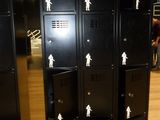 many black lockers with stickers on them in a room