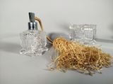 a bottle of perfume and a brush on a table