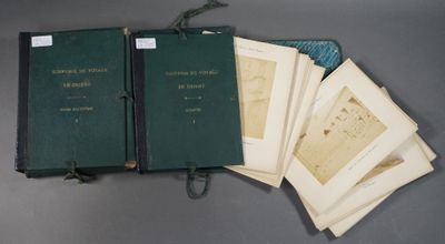 several books are lined up on a table with a bag