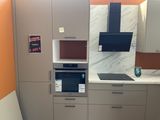 a kitchen with a microwave, oven, and cabinets in it