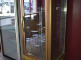 a glass display case in the corner of a room