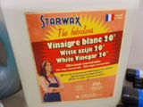 a container of starwax wax and a bottle of white vinegar