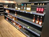 many bottles of alcohol on the shelves in the store