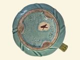 a blue and brown clock sitting on top of a table