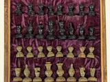 a box with chess pieces in it on a table