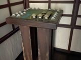 a small table with a chess board on it in a room