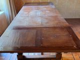 a wooden table that is sitting in the middle of a room
