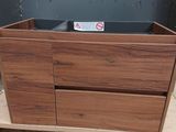 a wooden cabinet with two drawers and a sign on it
