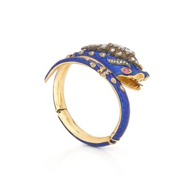 a close up of a gold ring with blue enamel and diamonds