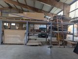 a large warehouse with a lot of wood on the floor