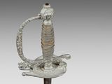 an image of a sword with a man holding a bird on it ' s back
