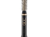 une brosse à cheveux noire et dorée avec un manche doré