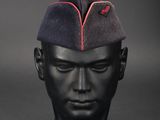 a black mannequin head with a red line on it