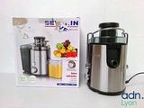 a silver and black juicer sitting next to a box of juice