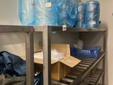 a metal shelf with a bunch of bags on top of it