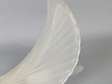 gold and white glass sculpture of a bird with wings on it ' s head
