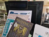a bunch of pamphlets on the counter of a restaurant