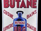 sign of a blue bottle of lubrie urc on the side of a building