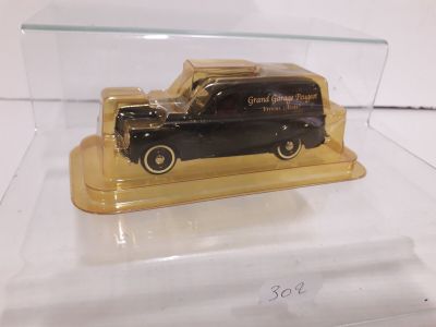a black car in a clear case on a white surface