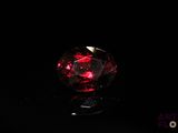 a close up of a red diamond on a black surface