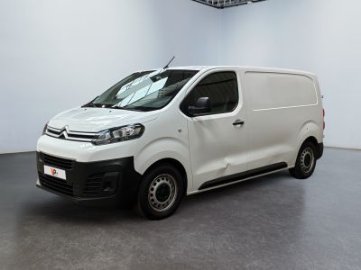 La camionnette blanche est garée dans la grande salle du bâtiment.