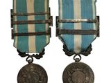 two medals are shown on a white background with a blue and white stripe