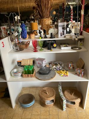 une étagère blanche sur laquelle sont posés des paniers et d'autres objets