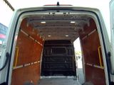 a white van that is parked in a lot with its doors open