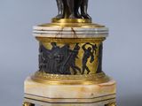 a statue of a man on a pedestal with a dog on it