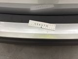 the rear bumper of a car with a sticker on it
