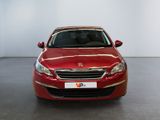 the red car is parked in a large room with a white wall