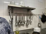 a person standing in a kitchen with a sink and a counter