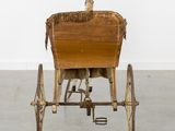 a horse drawn carriage with a basket on the back of it