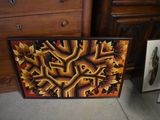 a picture of a painting on the floor next to a dresser