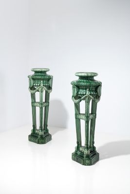 deux vases verts posés l'un à côté de l'autre sur une table