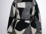 an image of a black and white coat on a mannequin