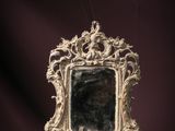 a mirror that is sitting on a purple surface
