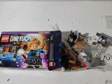 a box of legos sitting on a table next to a bag of legos