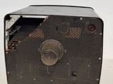 an old radio sitting on a table with a white background