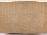 an old piece of brown paper on a white surface