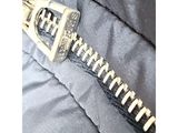 a close up of a zipper on a black jacket