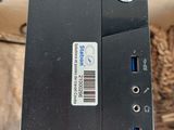 a small black computer sitting on top of a table
