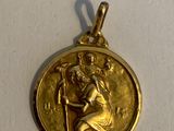 an image of a gold medal with a woman holding a child