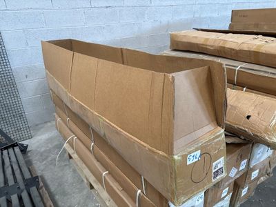 many cardboard boxes stacked on a pallet in a warehouse
